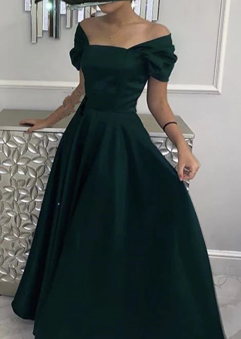Elegant green V-neck formal evening dress with a cinched waist, worn by a model.