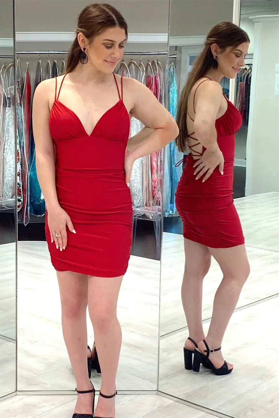 Woman wearing a red V-neck lace-up spaghetti strap mini homecoming dress.