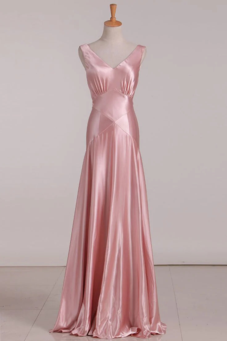 Model wearing a pink V-neck mermaid bridesmaid dress with a tie-back.