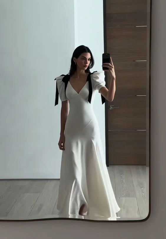 Close-up of the V-neckline and puff sleeve detail on the maxi dress.