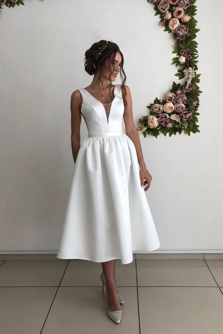 Model wearing an elegant V-neck satin tea-length bridesmaid dress.
