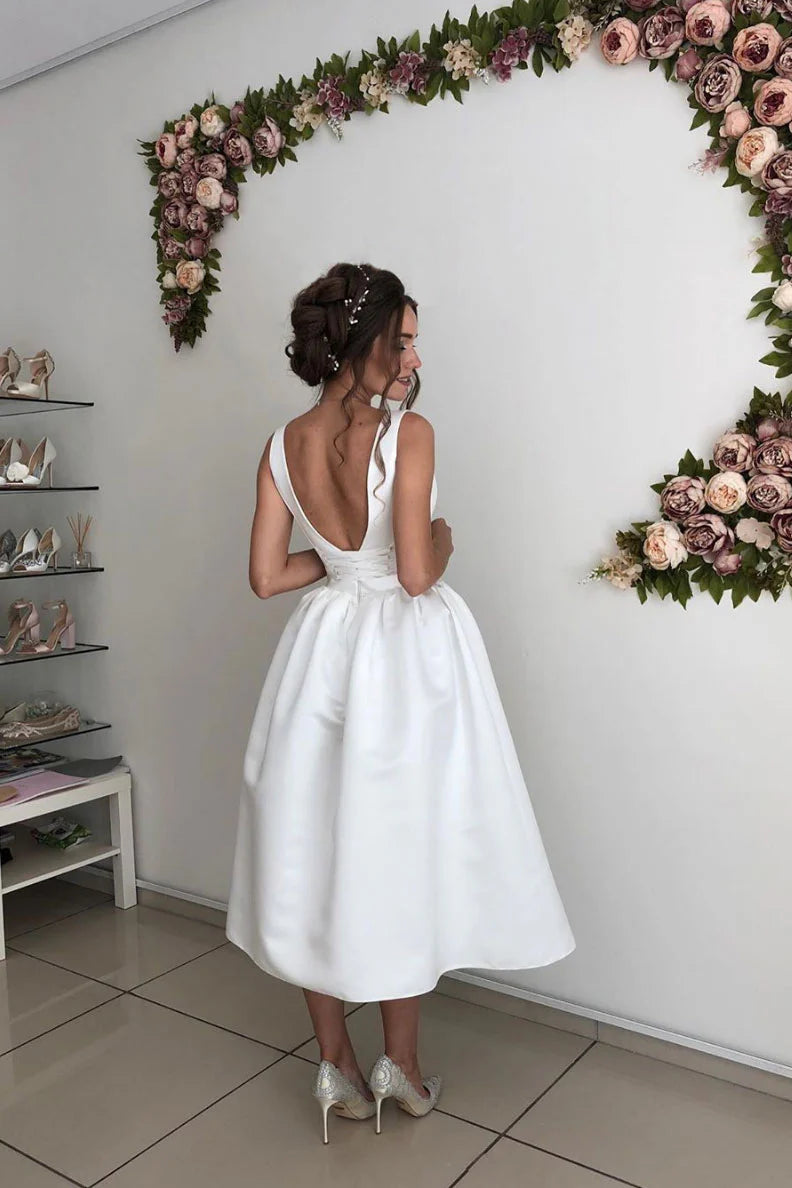 Full view of a model in a chic V-neck satin prom dress.