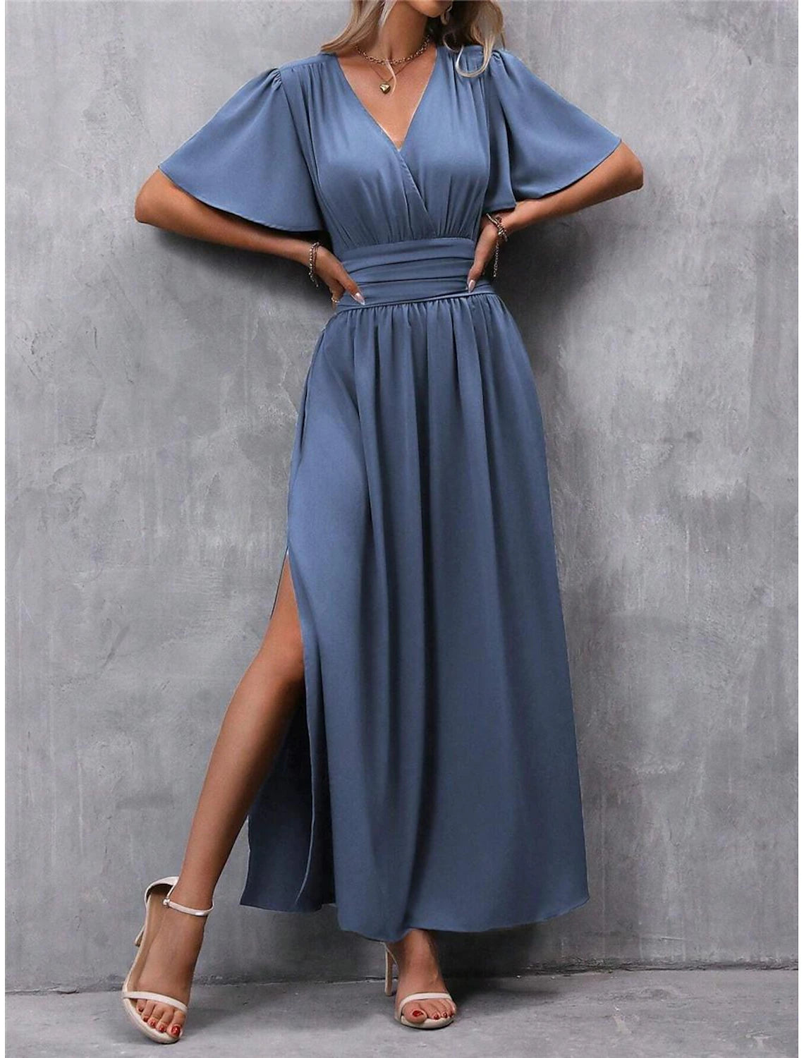 Woman wearing an elegant V-neck short sleeve maxi dress with a high waist and side split.