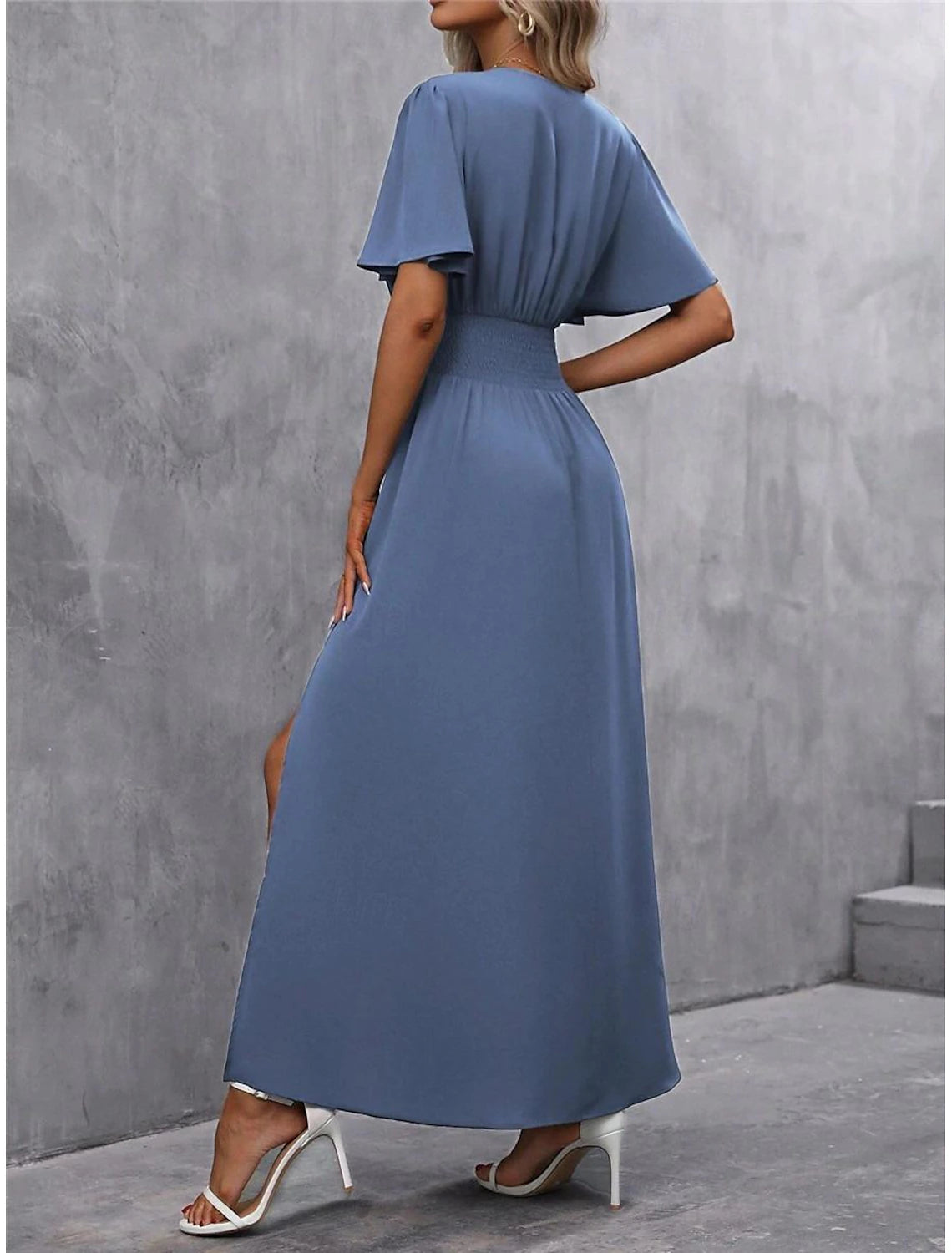 Back view of a woman in the elegant V-neck short sleeve maxi dress, showcasing its flowing silhouette.