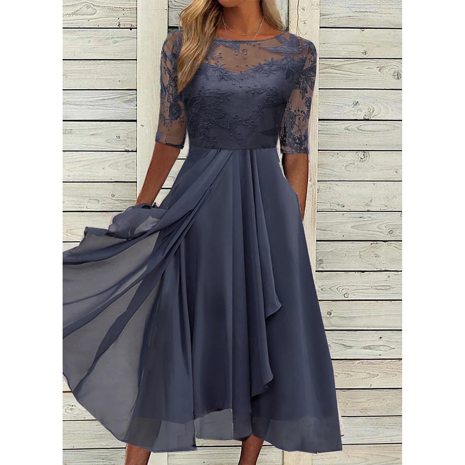 Woman wearing an elegant V-neck sleeveless floral embroidered lace midi cocktail dress.