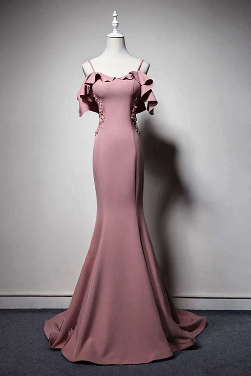 Woman wearing an elegant V-neck sleeveless pink mermaid long prom dress.