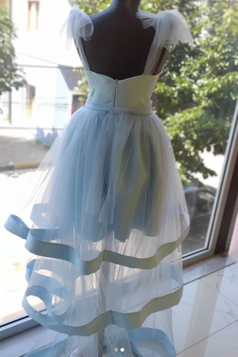 Full view of a model in a blue tulle short homecoming dress.
