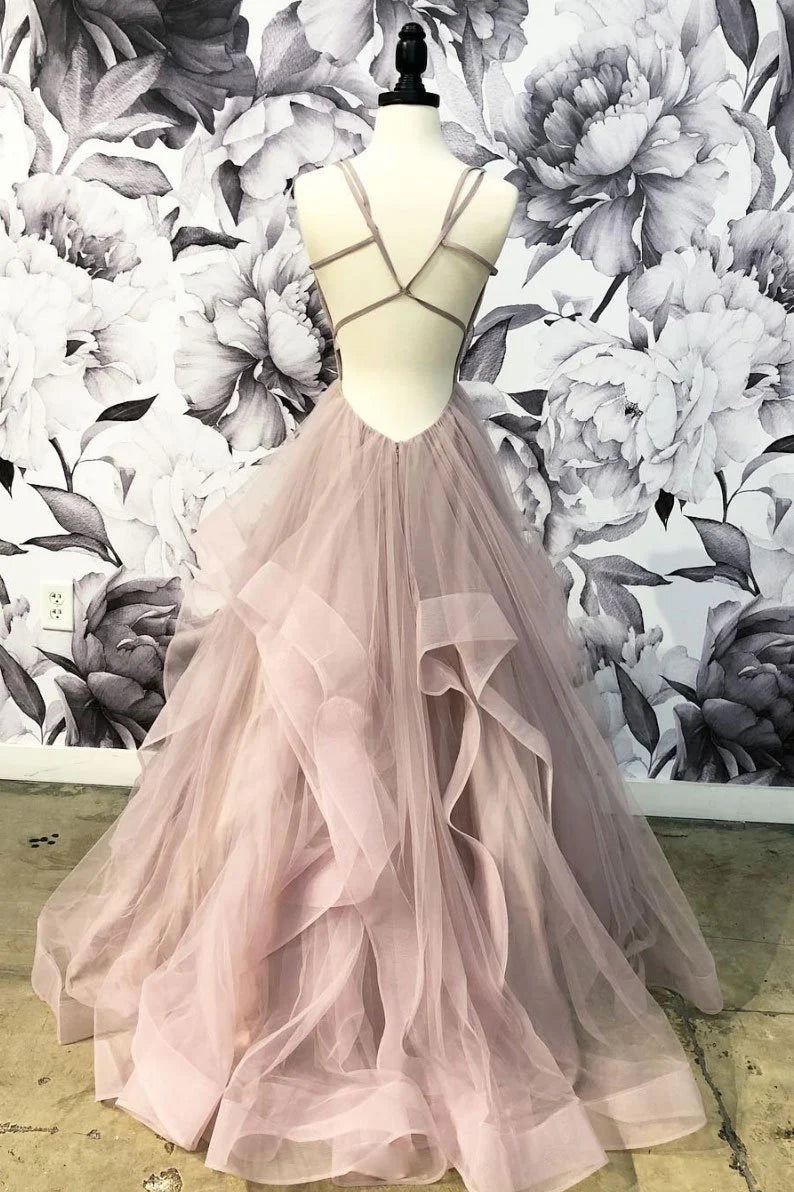 Back view of a woman in a flowing champagne tulle evening gown.