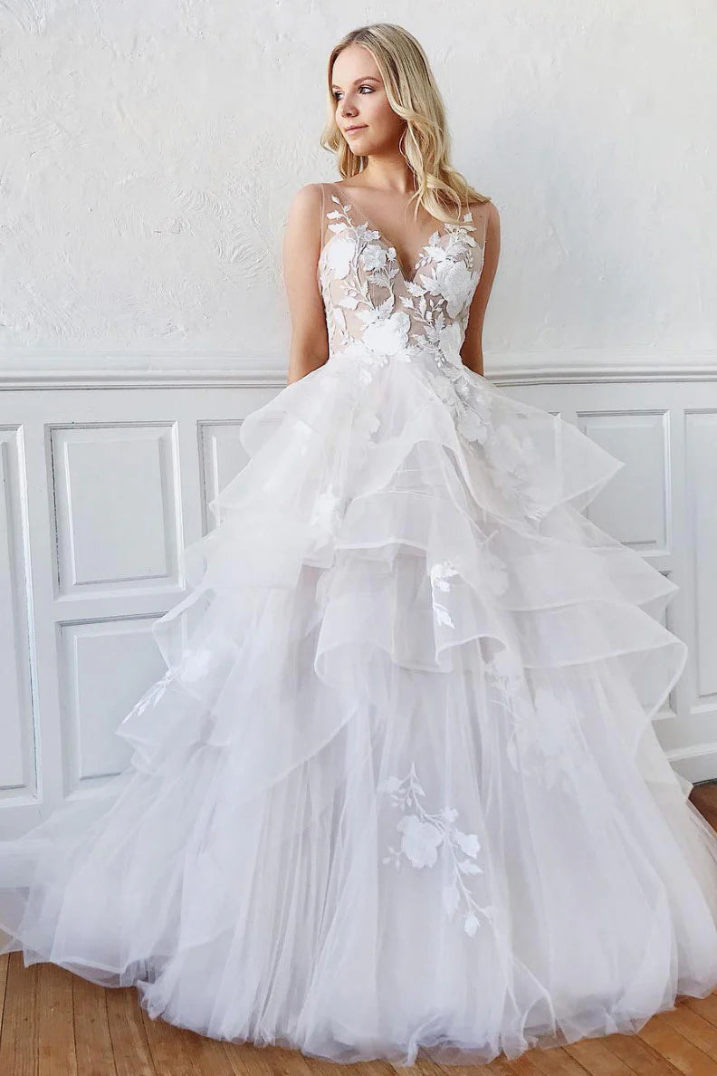 Woman wearing an elegant white V-neck tulle lace long prom dress.