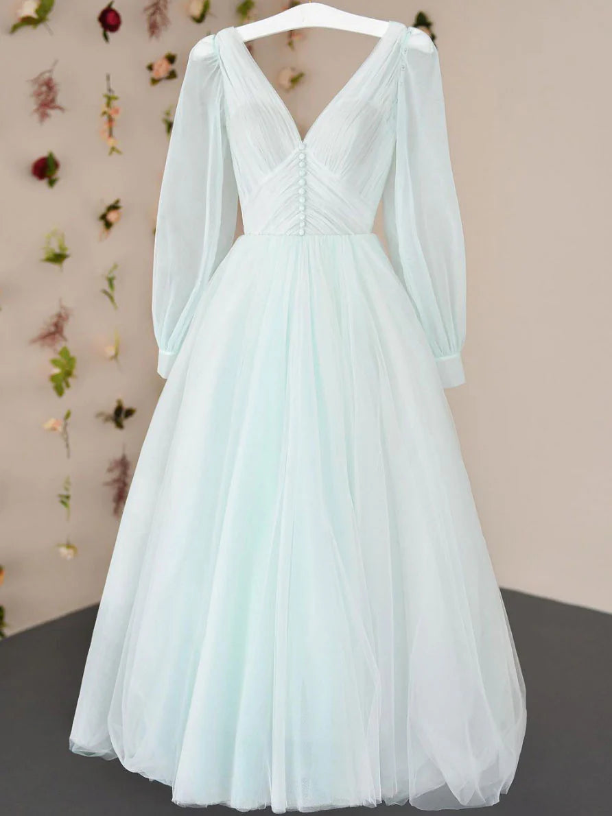 Woman wearing an elegant V-neck tulle tea-length prom dress with a cinched waist.