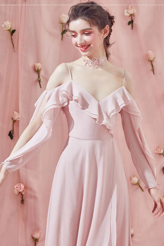 Side view of a woman in the elegant pink chiffon formal dress.