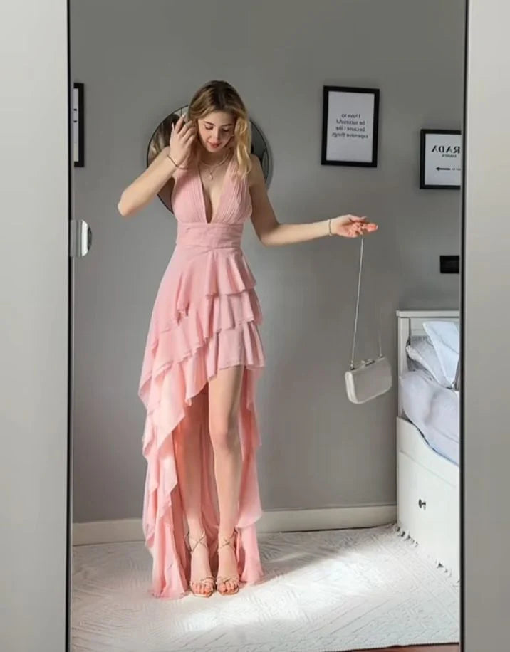 Elegant pink V-neck chiffon ballroom dress with cinched waist and layered skirt.