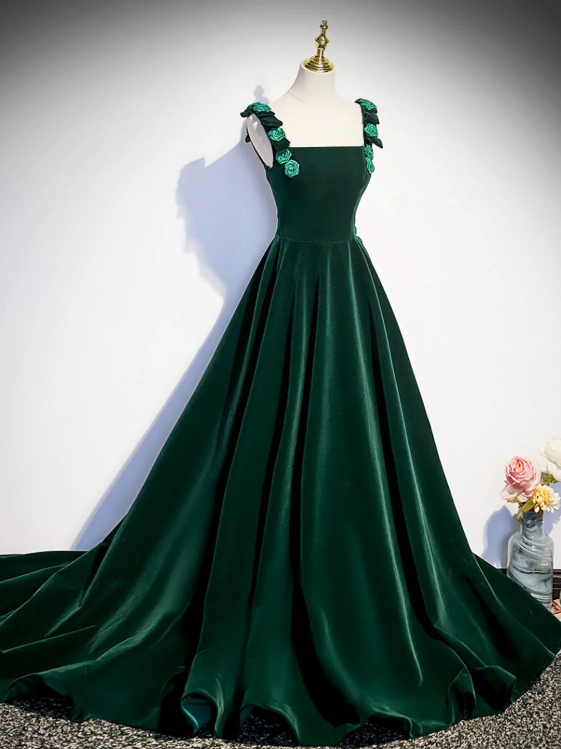 Model wearing an elegant green velvet A-line long prom dress with a lace-up back.