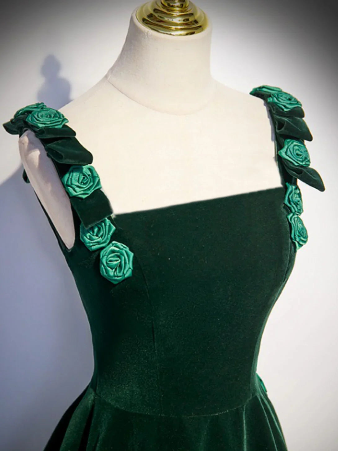 Side profile of the green velvet A-line formal evening dress.