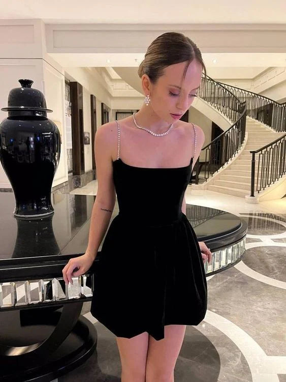 Model wearing an elegant dark velvet V-neck short dress.