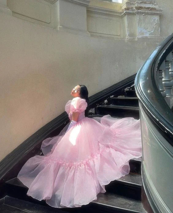 Side profile of a woman in the pink A-line organza evening gown.