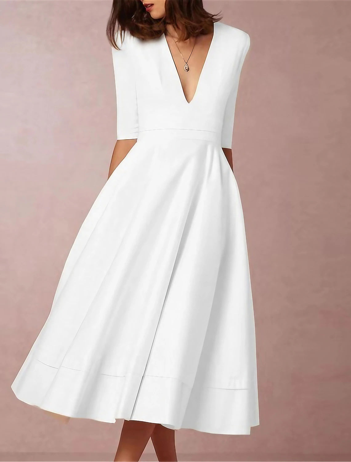 Woman wearing an elegant white ruched deep V-neck half sleeve semi-formal dress.