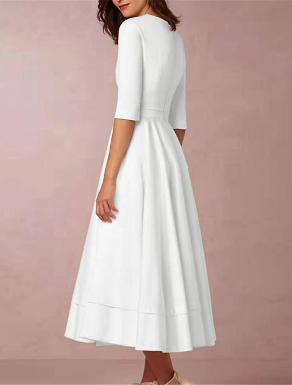 Back view of a woman in a white ruched deep V-neck half sleeve party dress.