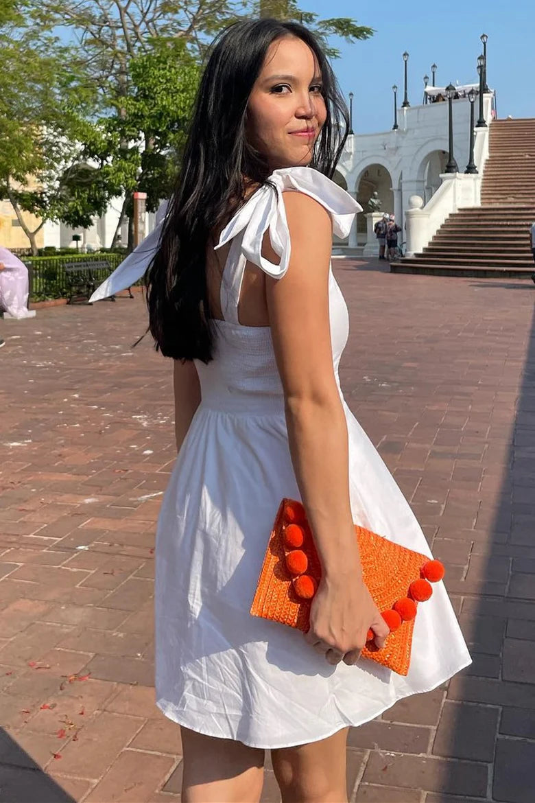 Close-up of the white square neck A-line mini party dress with bow straps.