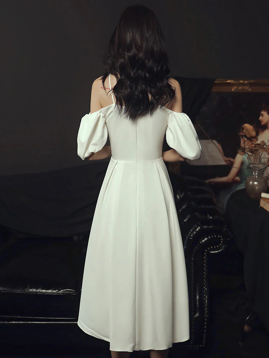 Back view of a white satin short party dress with a sweetheart neckline.
