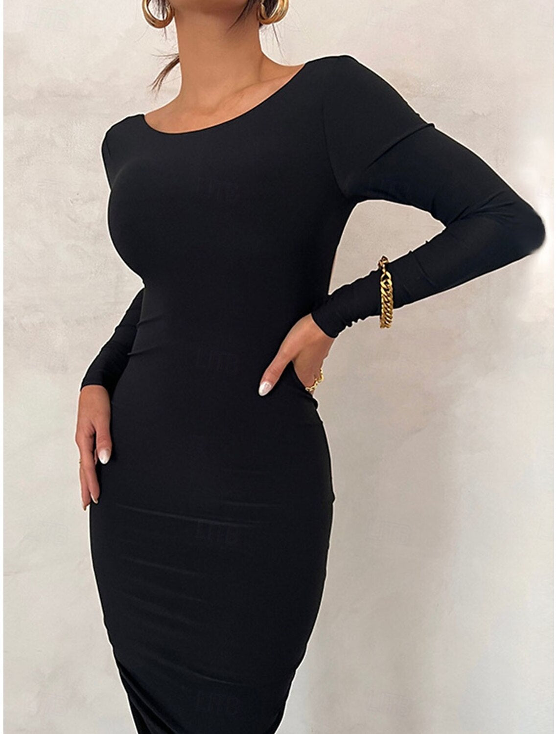 Woman wearing a black sheath slim-fit backless maxi dress.