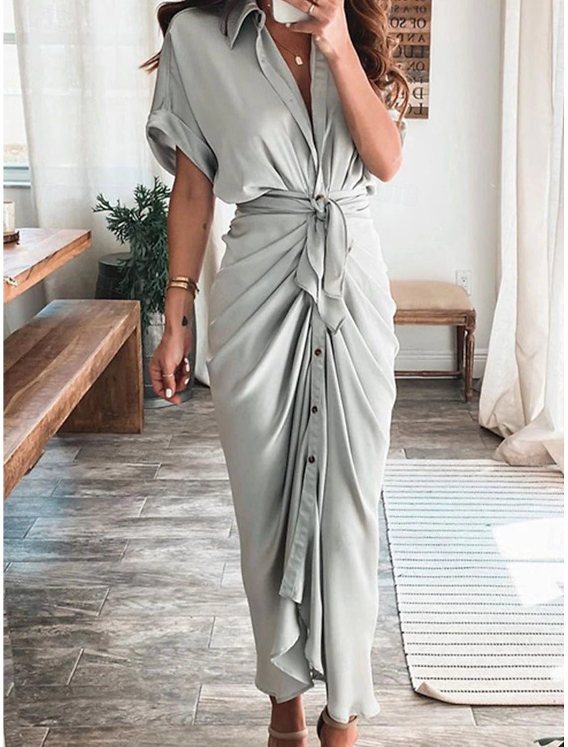 Woman wearing an elegant V-neck puff short sleeve wrap bodycon maxi dress.