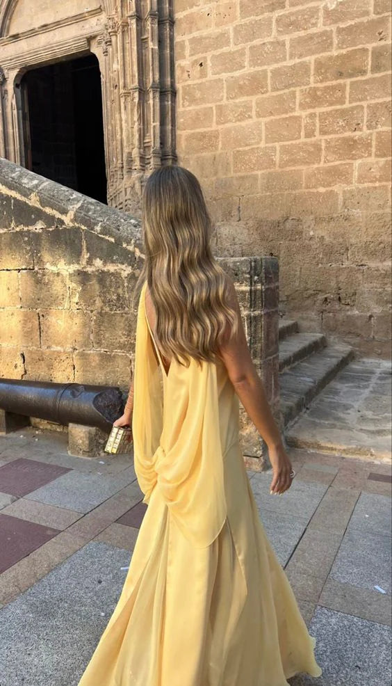 Close-up of the yellow satin fabric and V-neckline of the elegant prom dress.