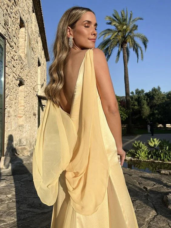 Side view of the yellow satin A-line prom dress, showcasing its flowing silhouette.