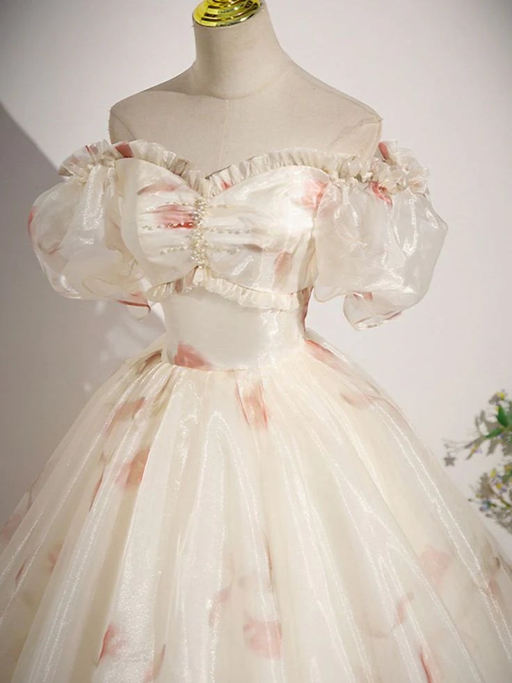 Woman wearing a floral chiffon A-line evening dress, side view.