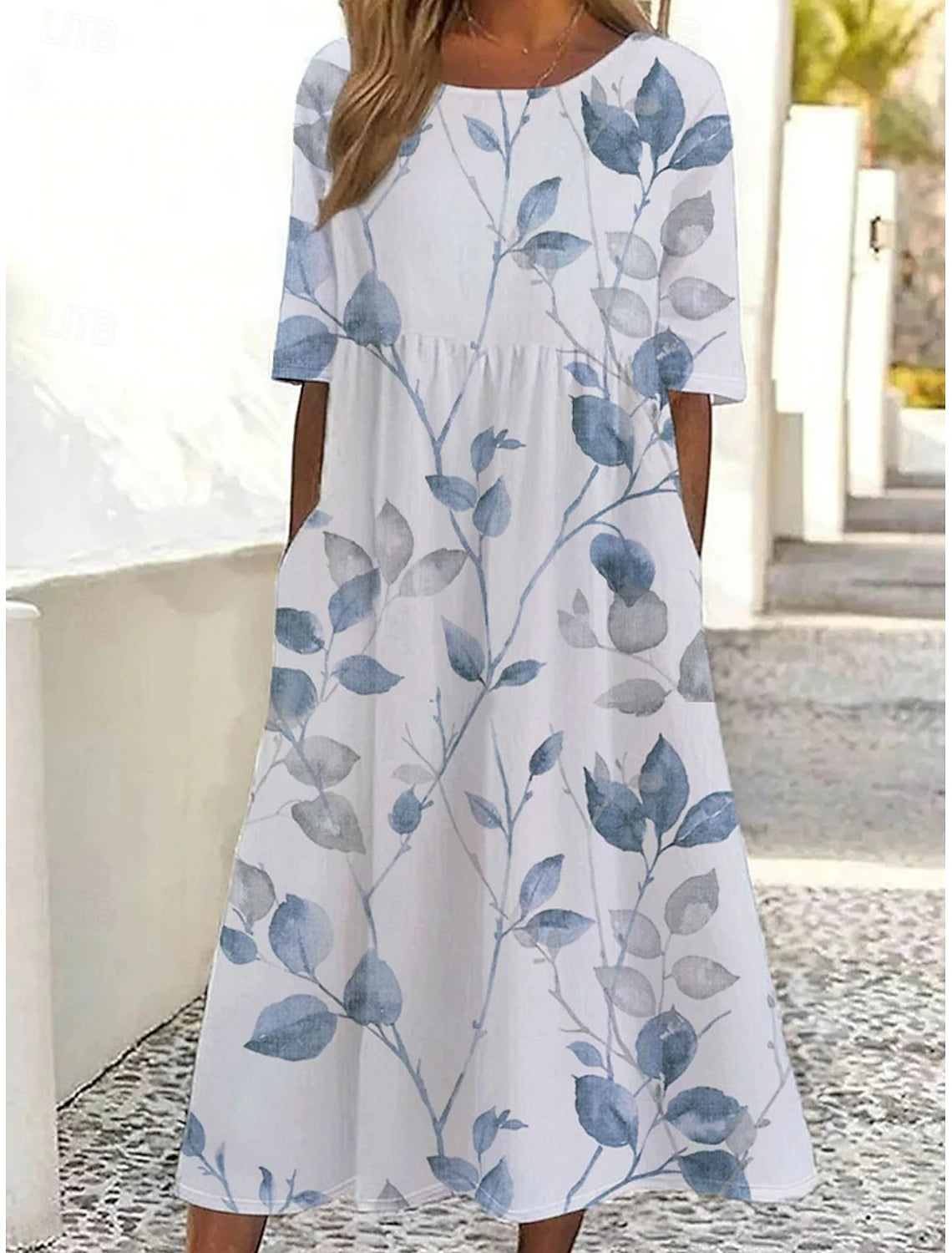 Woman wearing a light blue A-line V-neck sleeveless midi sundress.