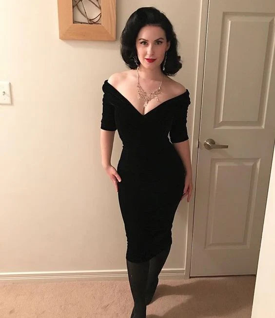 Woman wearing an elegant black off-shoulder mid-length prom dress.
