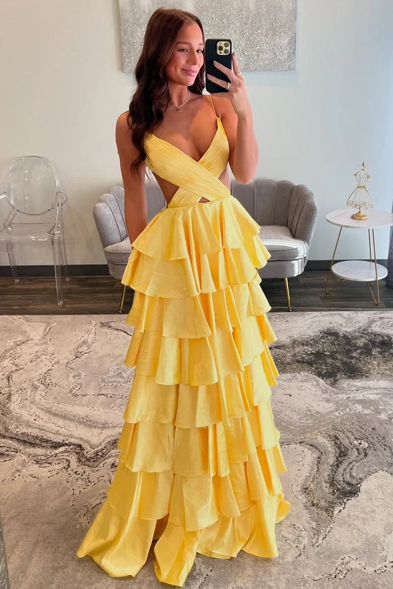 Full length view of a woman wearing a sophisticated spaghetti strap prom gown with a V-neck.