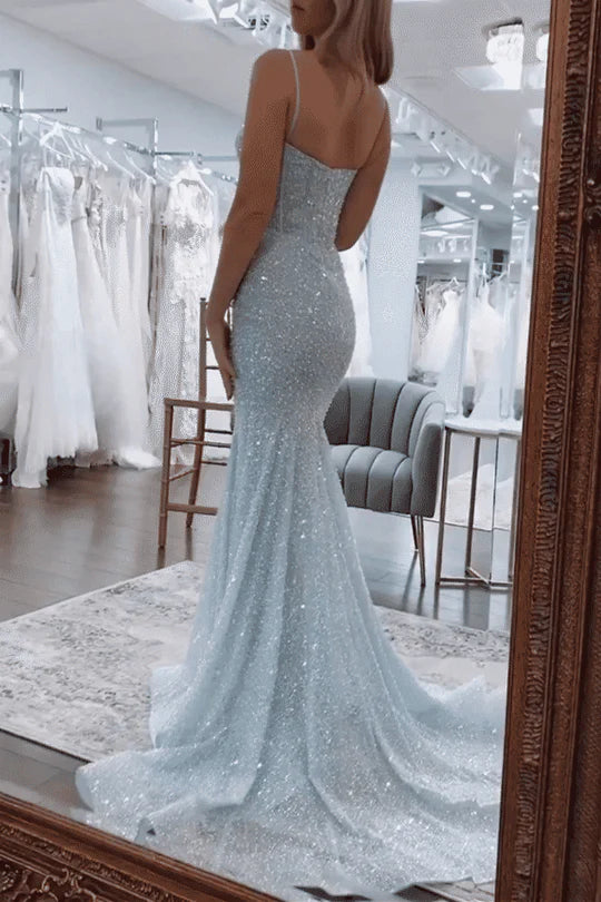Woman in a glittering mermaid spaghetti strap long prom dress.