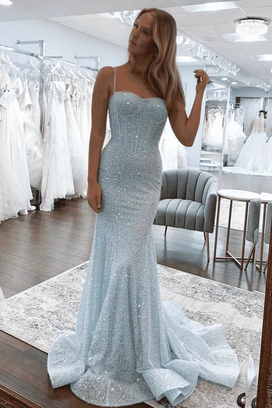 Back view of a woman in a glittering mermaid formal gown.