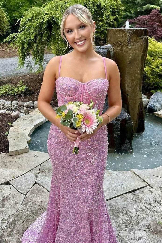 Side view of a woman posing in a sparkling mermaid party dress.