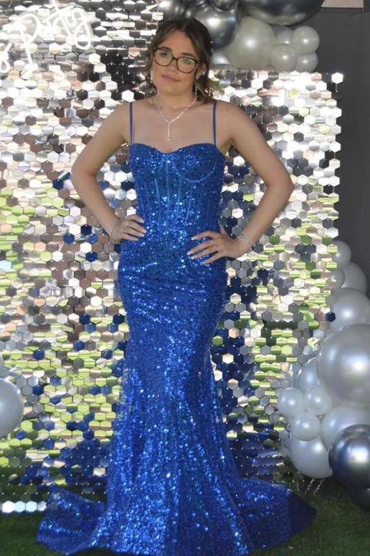 Woman in a full-length glittering mermaid dress with spaghetti straps.
