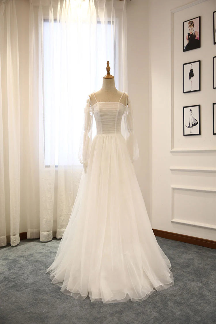 Model wearing an elegant white off-shoulder long tulle prom dress.
