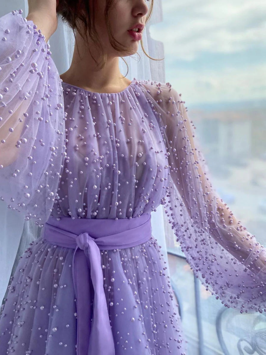 Back view of a purple A-line evening gown with round neck and beaded tulle.