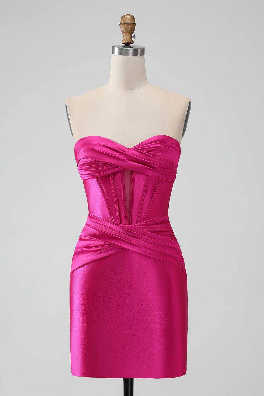 Model wearing a hot pink slim-fit strapless ruched mini dress, front view.