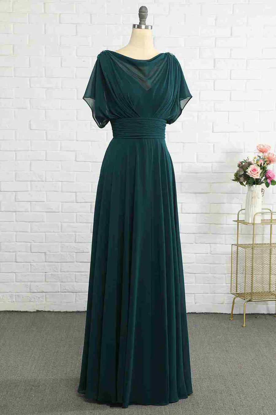 Hunter green chiffon bridesmaid dress with bateau neckline and long gathered skirt.