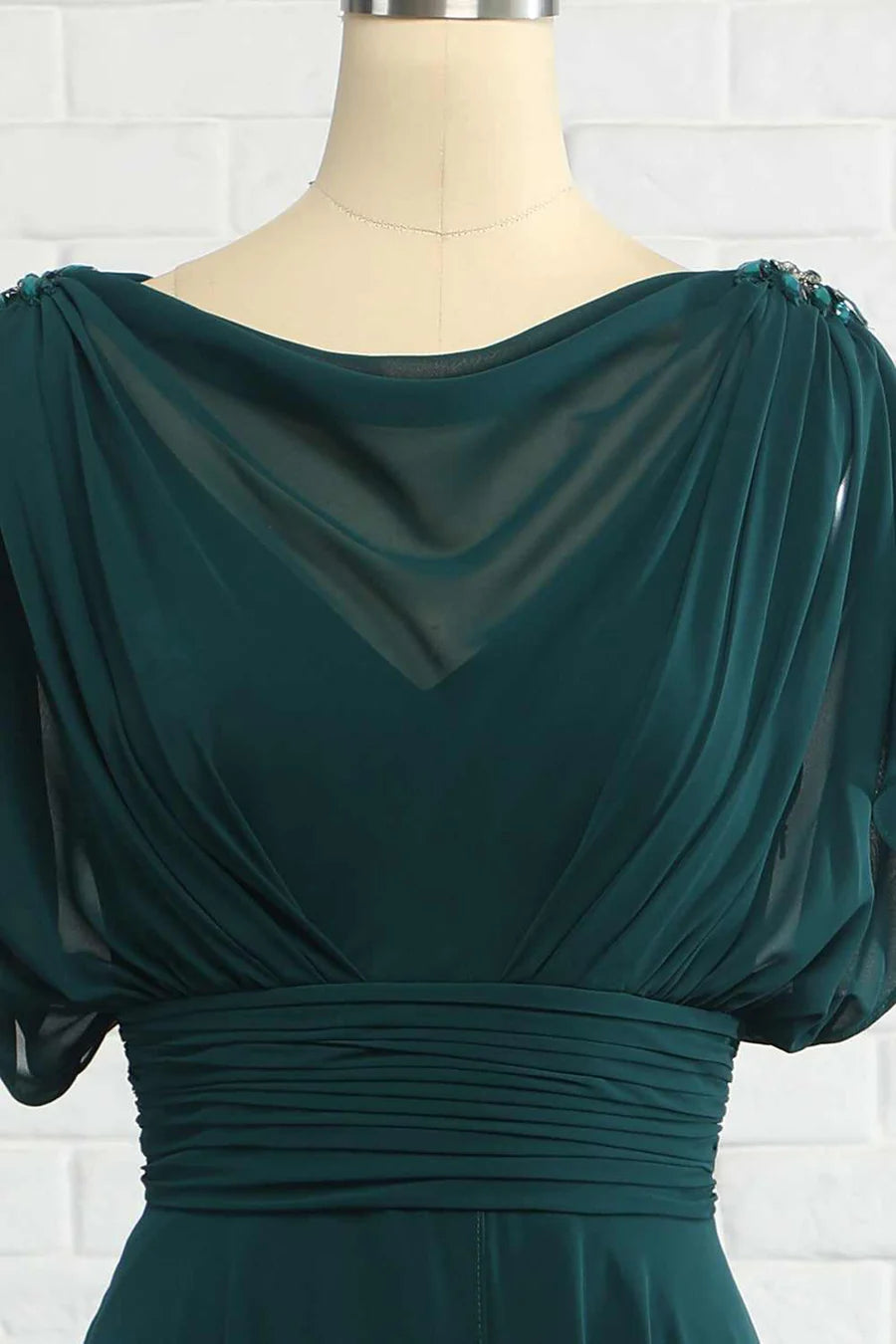 Close-up of the bateau neckline and banded waist on a hunter green chiffon dress.
