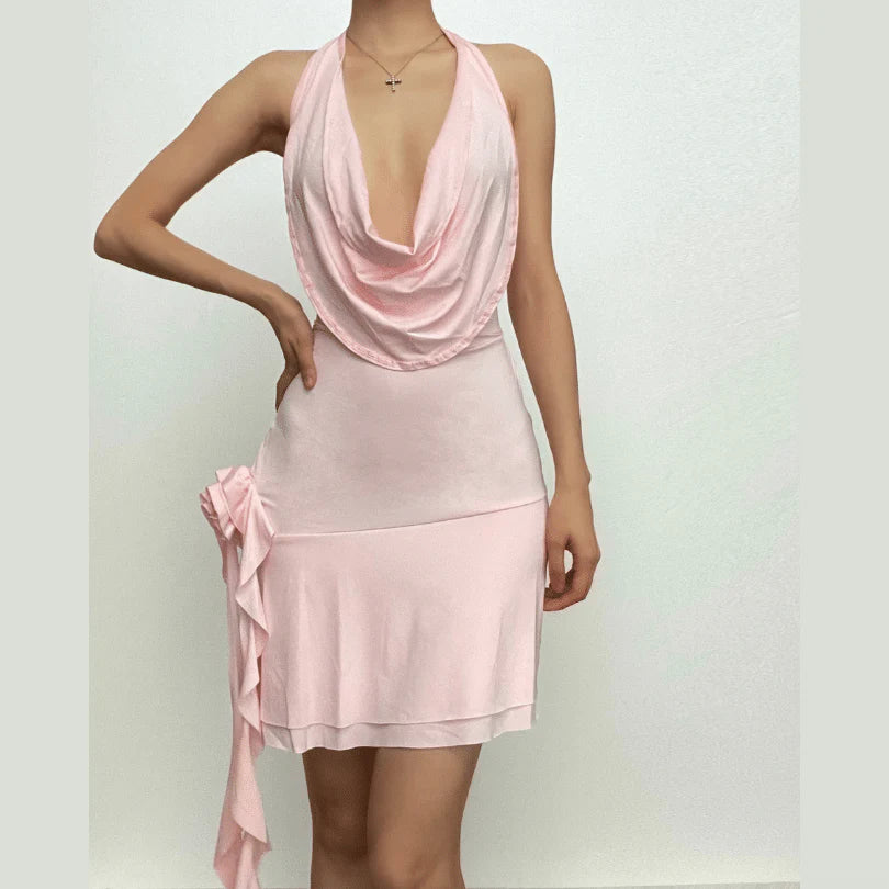 Front view of a woman wearing a pink halter cowl neck bodycon mini dress with ruched details.