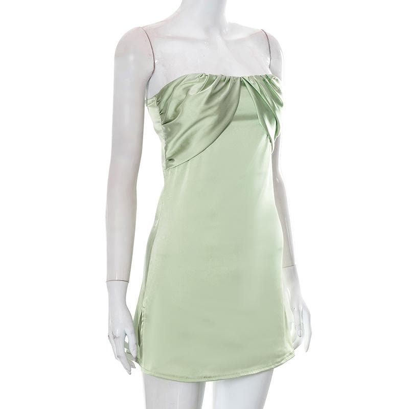 Close-up of the sweetheart neckline and ruched detailing on the sage green dress.