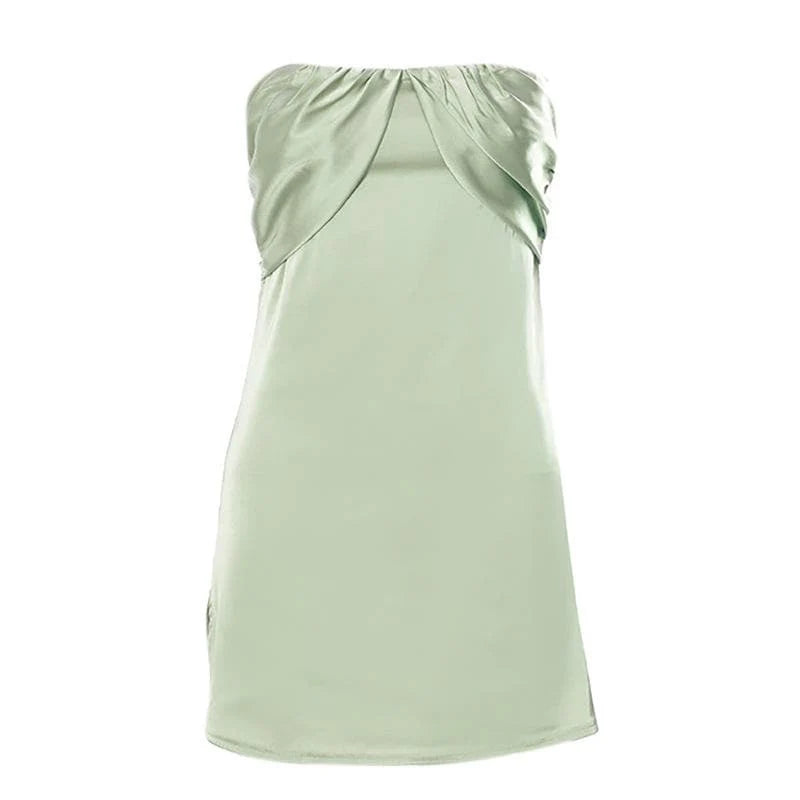 Model posing in the sage green mini dress, highlighting the short slit.