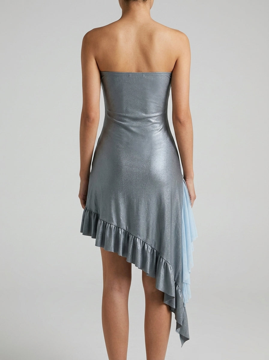 Side view of shimmering grey strapless dress, highlighting ruffled asymmetrical hem.