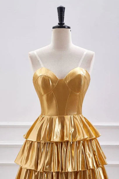 Model in shimmering metallic A-line off-shoulder ruffle homecoming dress.
