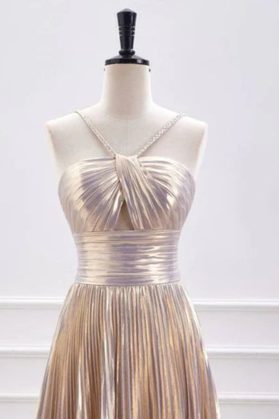 Full-length view of a woman wearing a shimmering metallic A-line homecoming dress with spaghetti straps.
