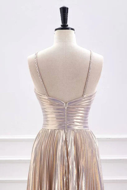 Close-up of the metallic fabric and pleated details on the waist-cinching A-line dress.