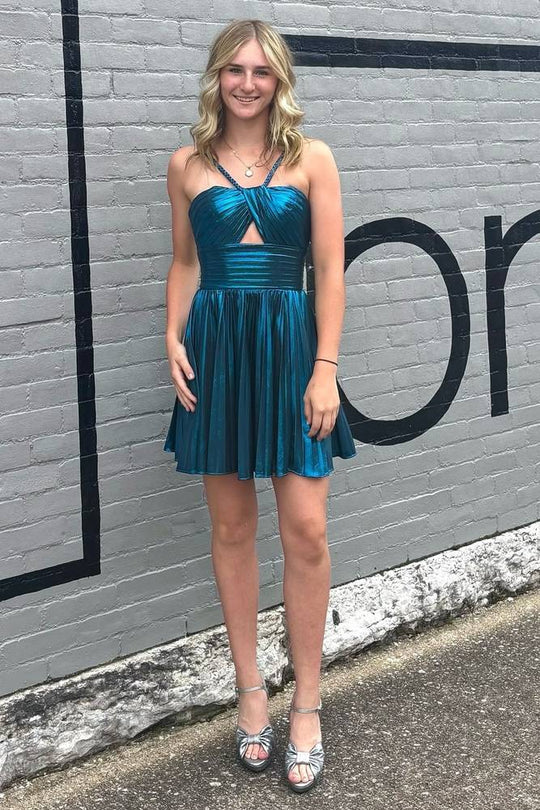 Woman posing in the metallic A-line dress, showcasing its flowy skirt.