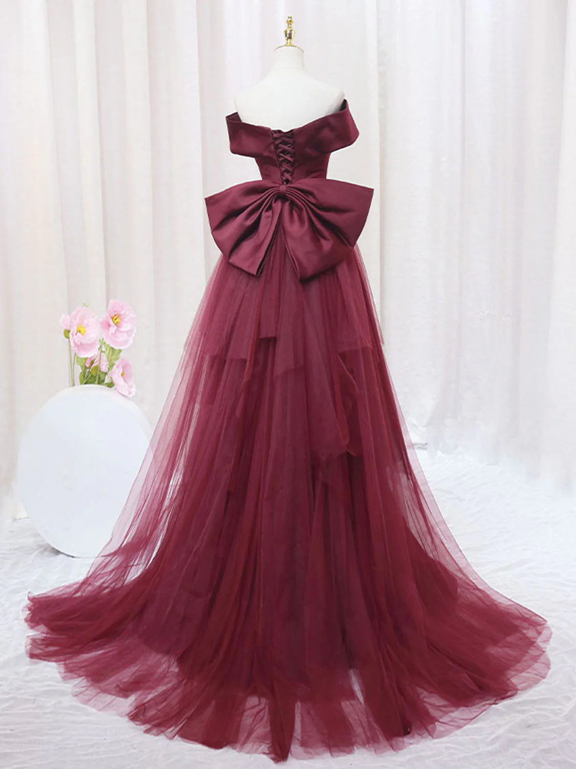 Woman modeling the elegant burgundy mermaid formal evening dress.